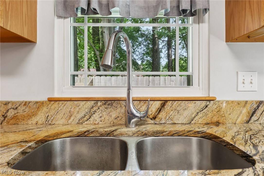 3213 Bates Road Madison, OH 44057 - Photo 17 of 45 Double-basin stainless steel sink with a high-arc faucet set into a granite countertop