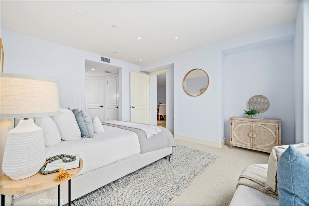 5082 Scholarship Irvine, CA 92612 - Photo 12 of 30 a spacious bedroom with a bed and a couch