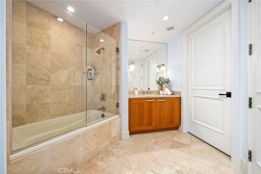 5082 Scholarship Irvine, CA 92612 - Photo 14 of 30 a spacious bathroom with a tub shower sink and mirror