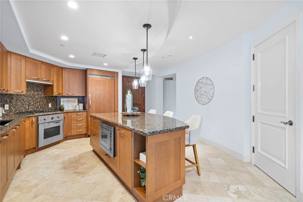 5082 Scholarship Irvine, CA 92612 - Photo 3 of 30 a kitchen with stainless steel appliances granite countertop a stove oven and a refrigerator