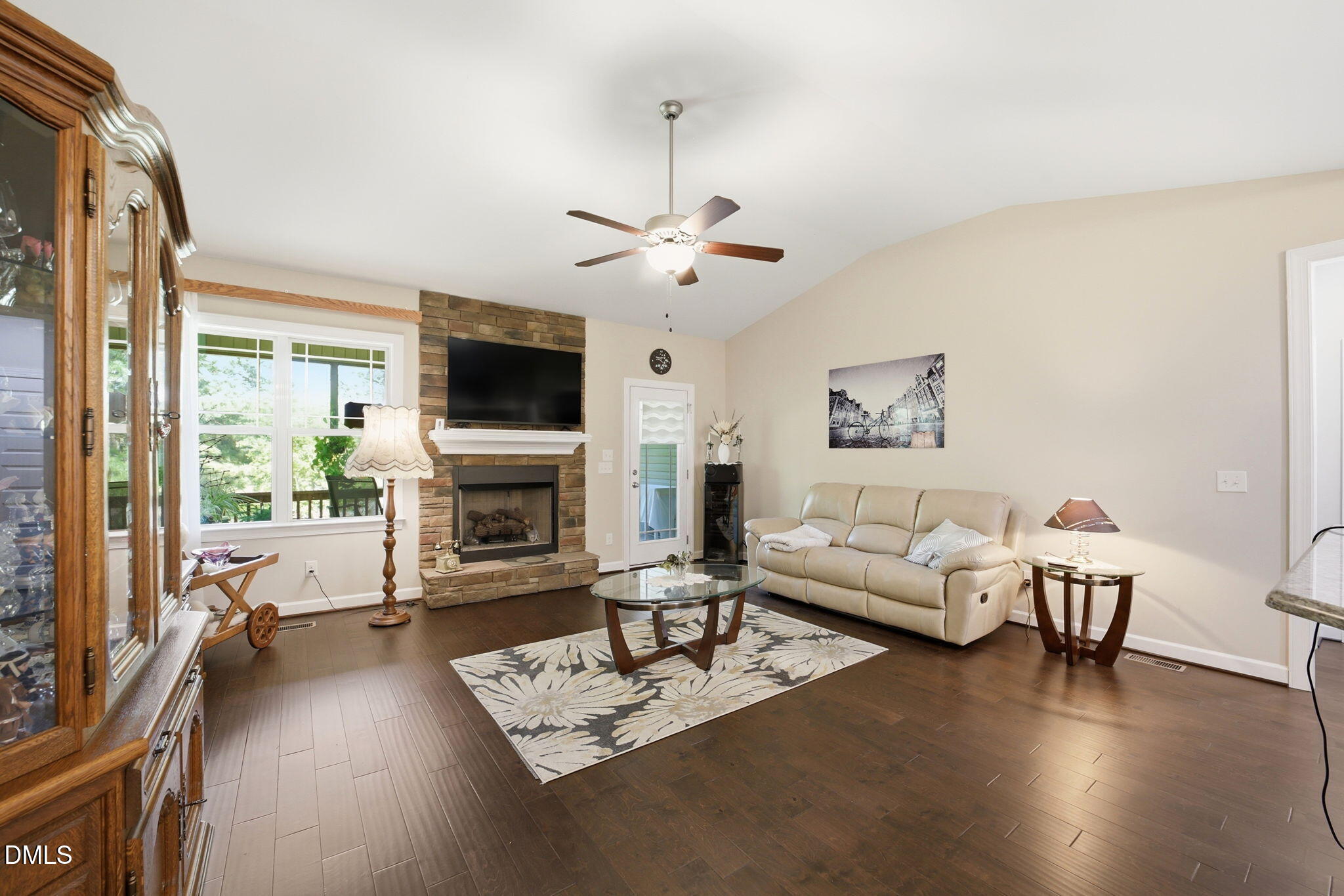 1547 Lassiter Pond Road Four Oaks, NC 27524 - Photo 10 of 45 a living room with furniture a fireplace and a flat screen tv