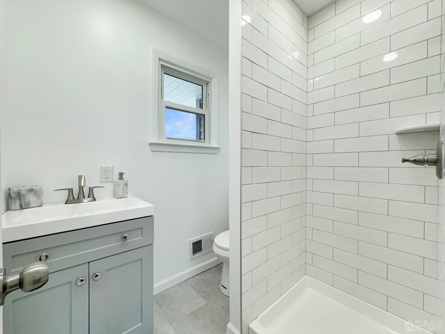 25 Mercer Road Old Bridge, NJ 08857 - Photo 18 of 30 a bathroom with a sink a toilet and shower