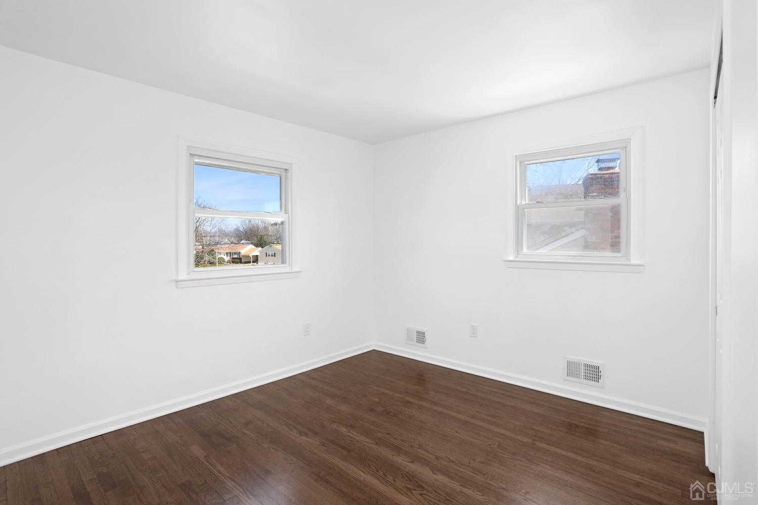 25 Mercer Road Old Bridge, NJ 08857 - Photo 21 of 30 an empty room with wooden floor and windows