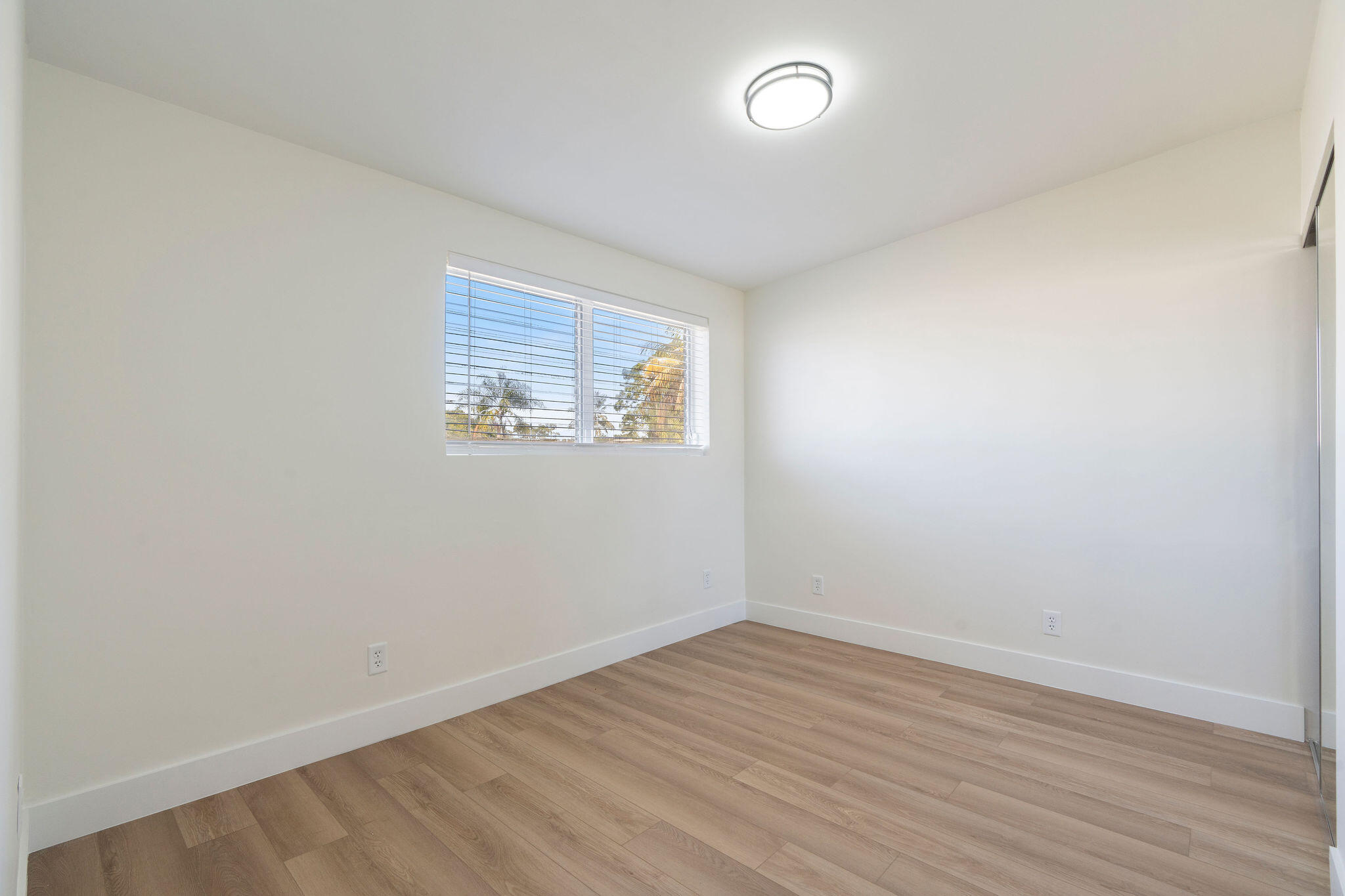 5580 Maypop Road West Palm Beach, FL 33415 - Photo 11 of 41 an empty room with wooden floor and windows