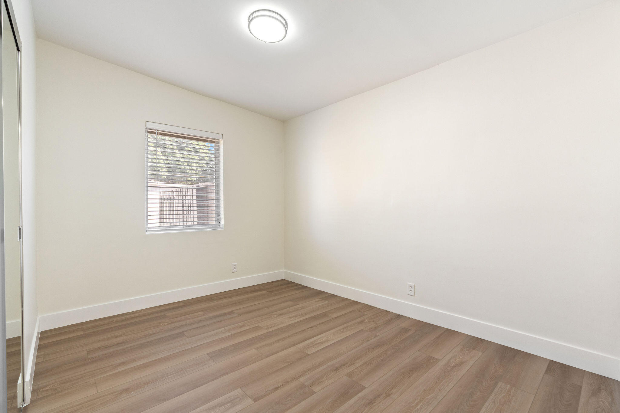5580 Maypop Road West Palm Beach, FL 33415 - Photo 12 of 41 an empty room with wooden floor and windows