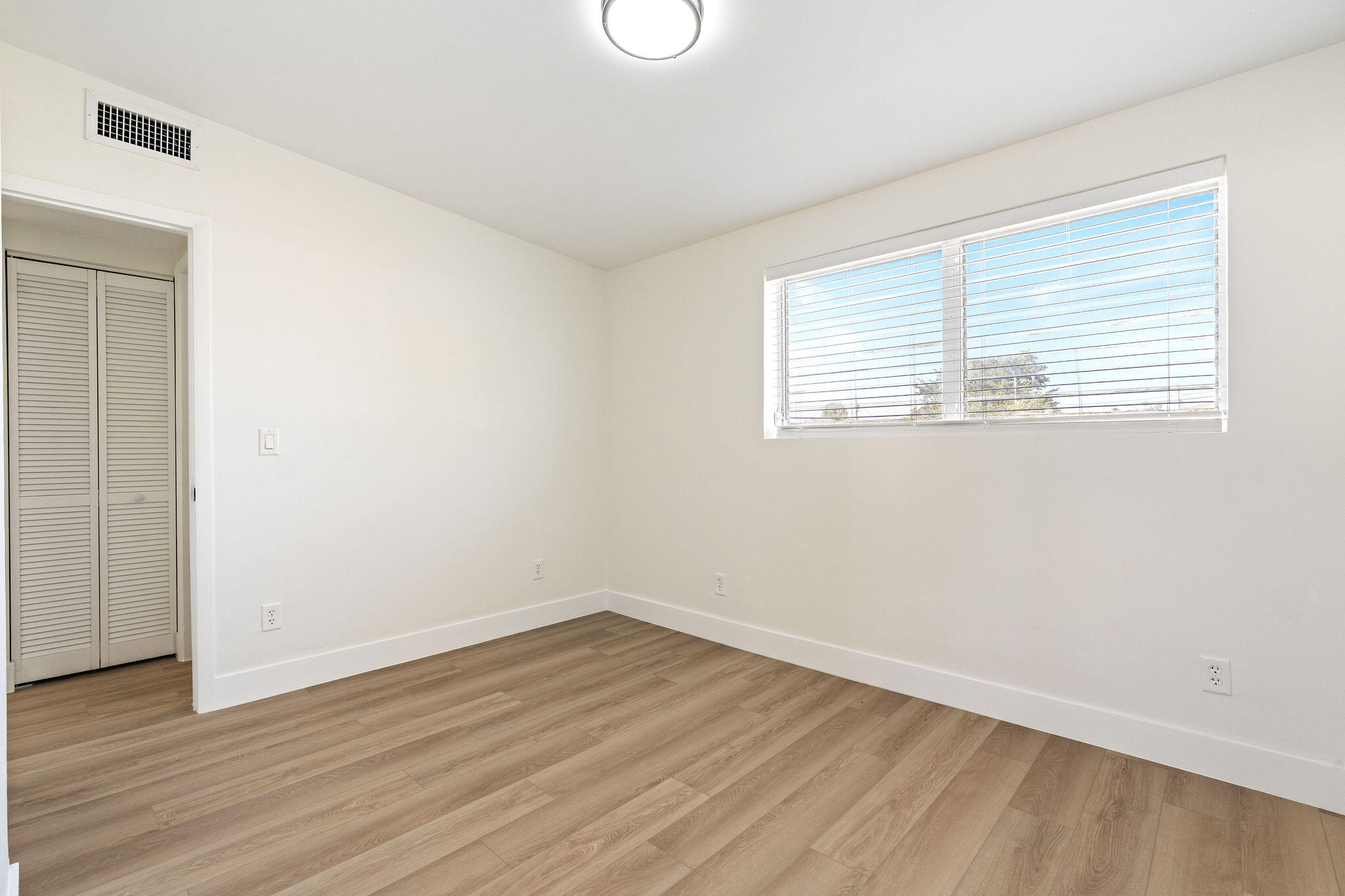 5580 Maypop Road West Palm Beach, FL 33415 - Photo 13 of 41 wooden floor in an empty room with a window