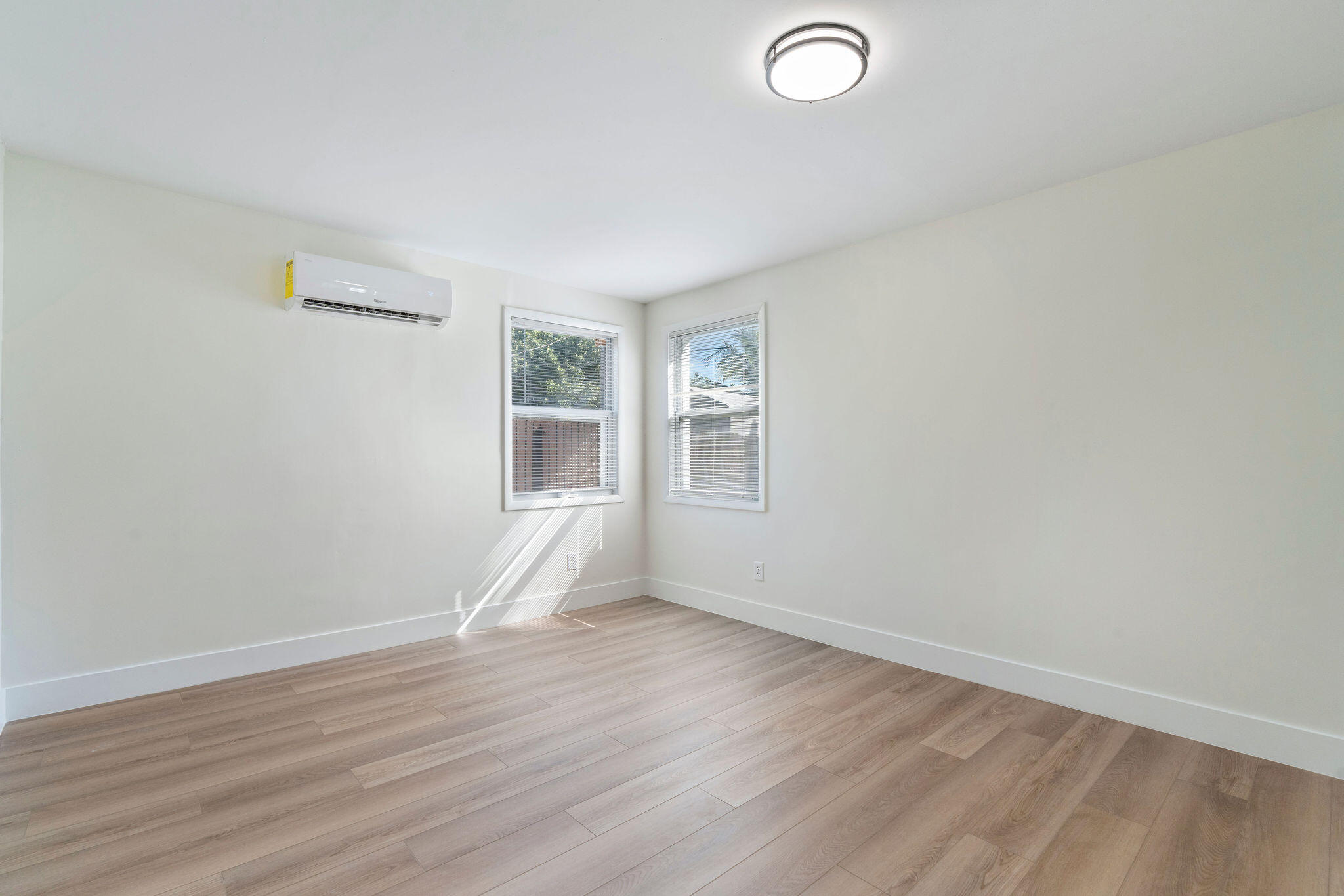 5580 Maypop Road West Palm Beach, FL 33415 - Photo 14 of 41 an empty room with wooden floor and windows