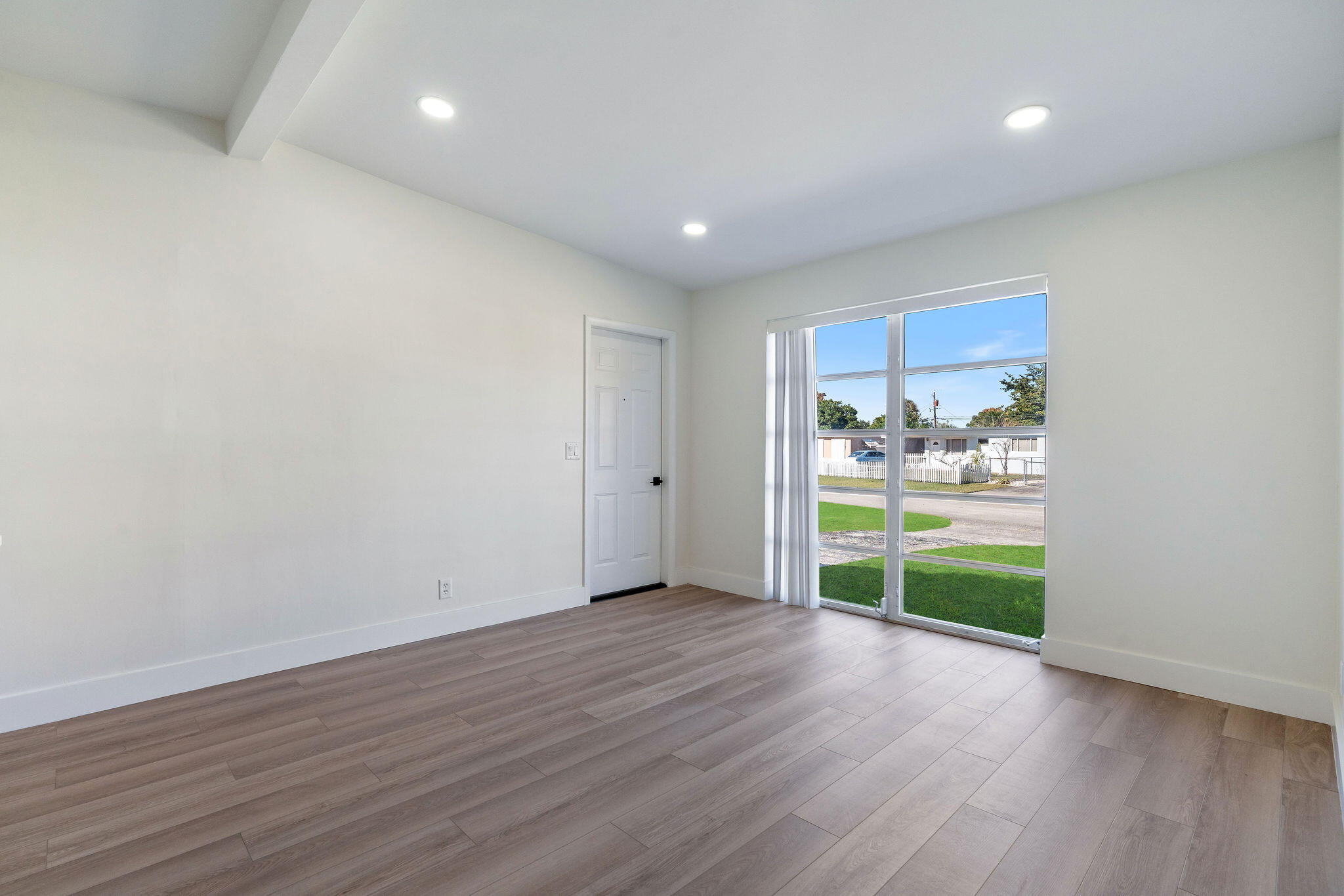 5580 Maypop Road West Palm Beach, FL 33415 - Photo 17 of 41 a view of an empty room with a window and wooden floor