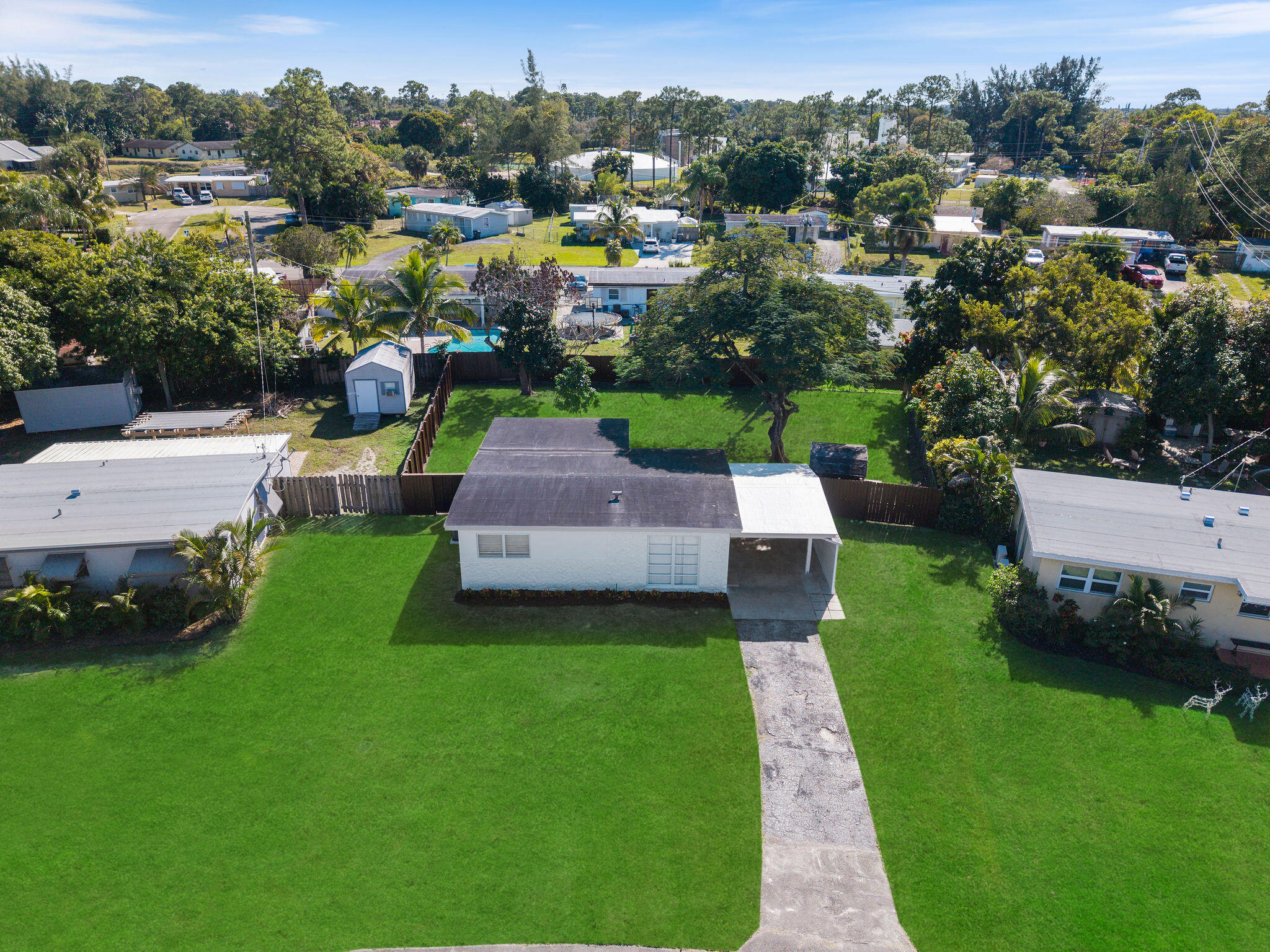 5580 Maypop Road West Palm Beach, FL 33415 - Photo 30 of 41 a view of a garden with lawn chairs plants and large tree