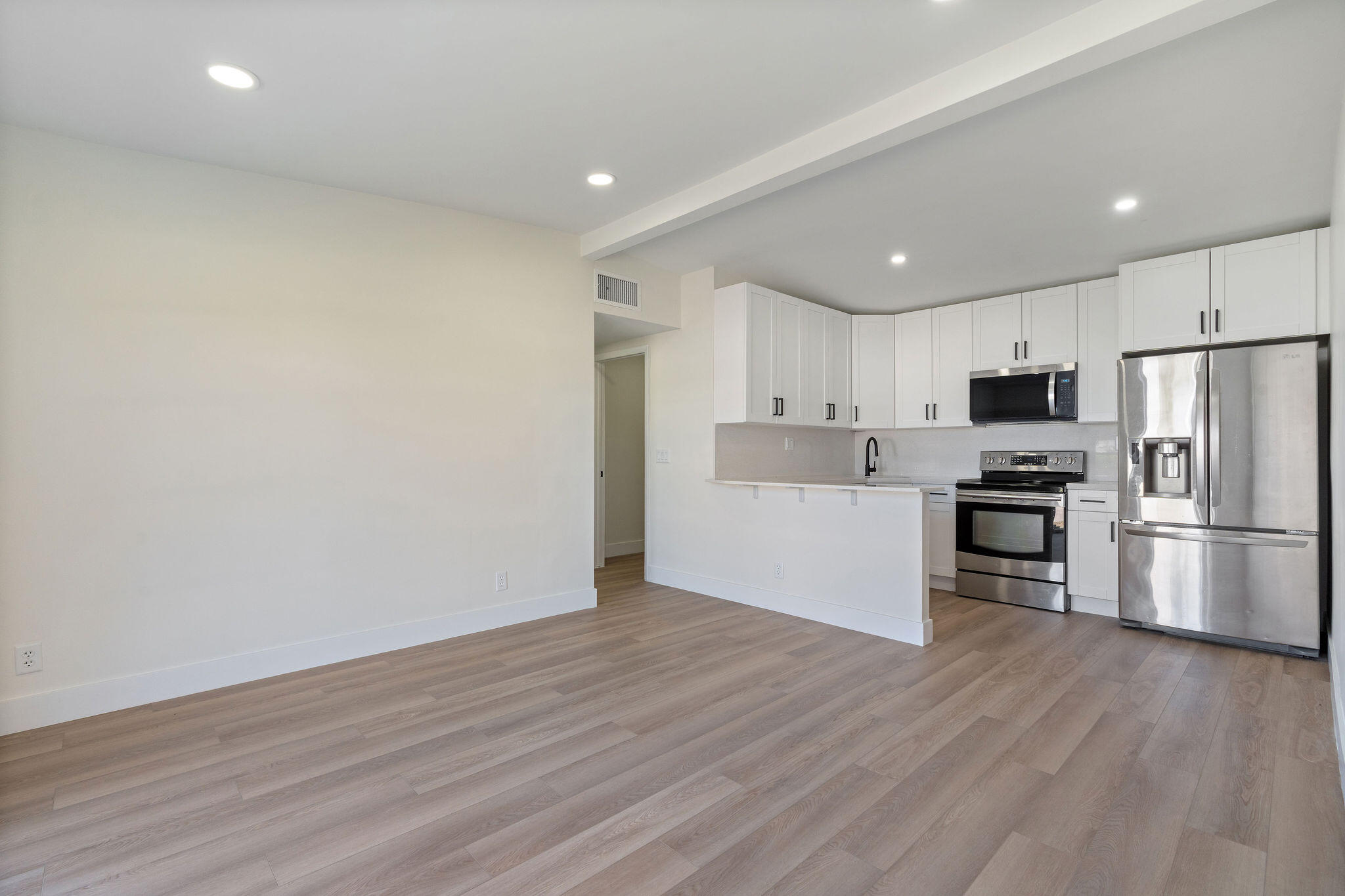 5580 Maypop Road West Palm Beach, FL 33415 - Photo 5 of 41 a view of kitchen view wooden cabinets and stainless steel appliances