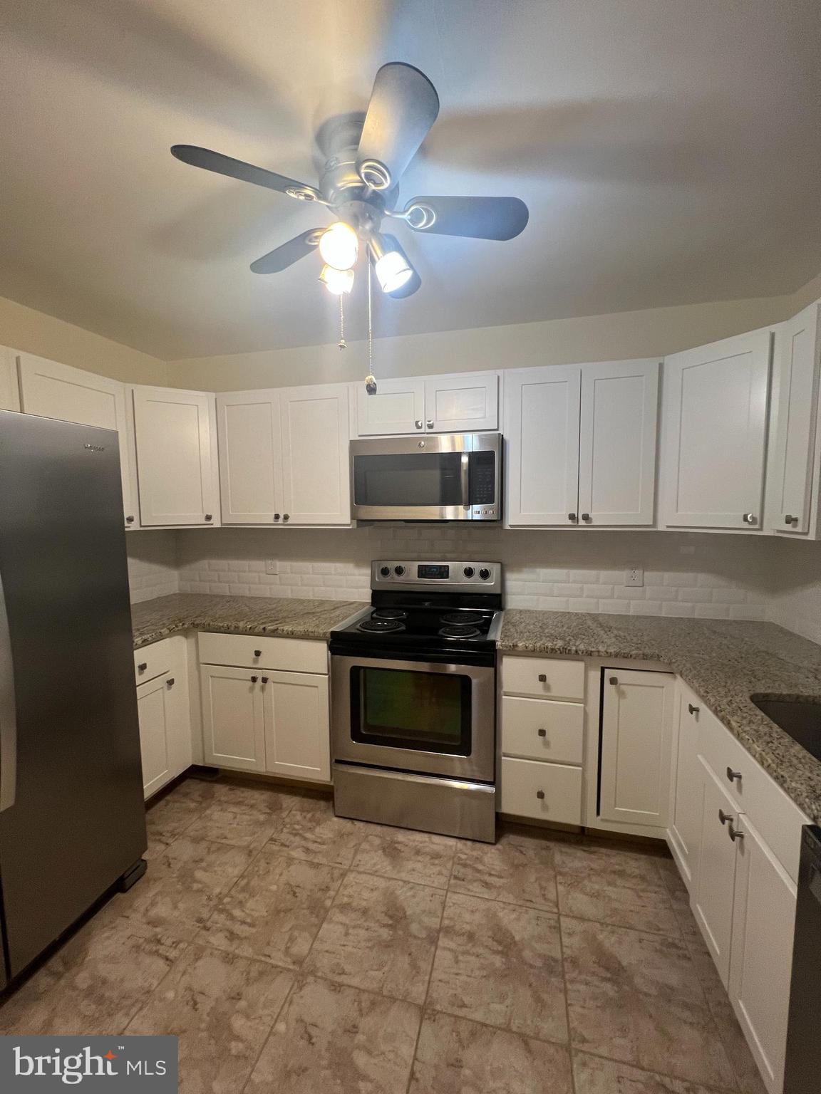 25 South Church Road Maple Shade, NJ 08052 - Photo 12 of 25 a kitchen with stainless steel appliances granite countertop a stove cabinets and a refrigerator