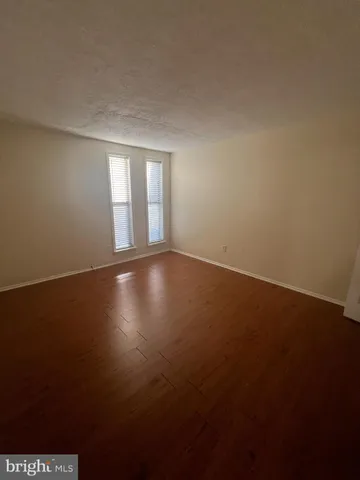 a view of room and hall with wooden floor