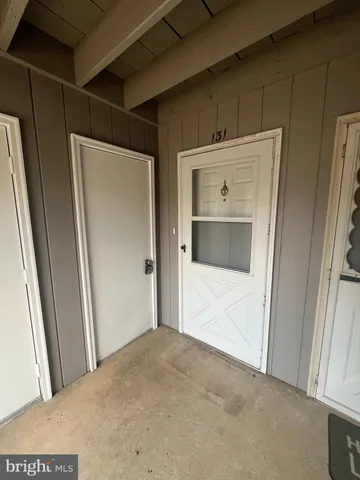 a view of a hallway to rooms