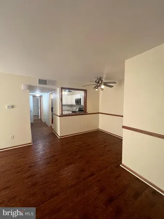 a view of a kitchen with wooden floor and electronic appliances