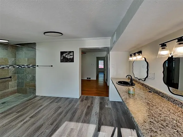 a living room with wooden floor furniture and a wooden floor