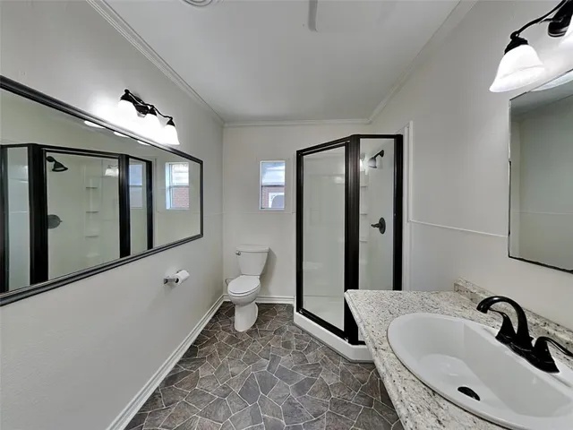 a bathroom with a sink a toilet and mirror