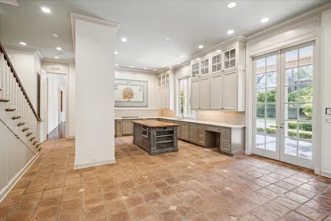 a large white kitchen with granite countertop a stove a sink a refrigerator and a granite counter top
