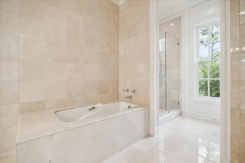 a spacious bathroom with a bathtub and shower