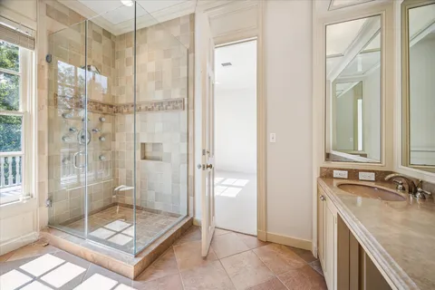 a bathroom with a shower sink and mirror