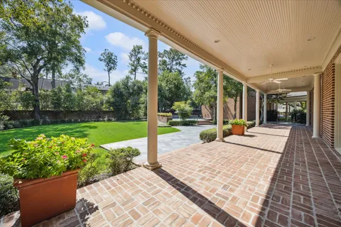 a view of a patio with a table chairs and garden
