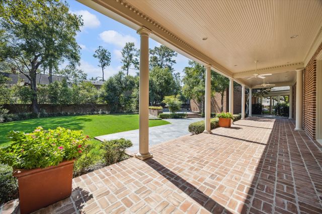a view of a patio with a table chairs and garden