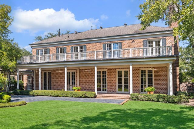 front view of a brick house with a yard