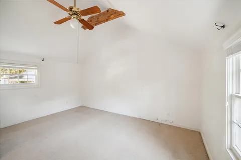 a front view of a house with a garden and tree