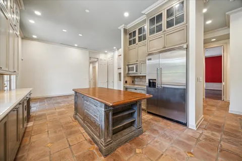 a kitchen with stainless steel appliances granite countertop a refrigerator and a sink