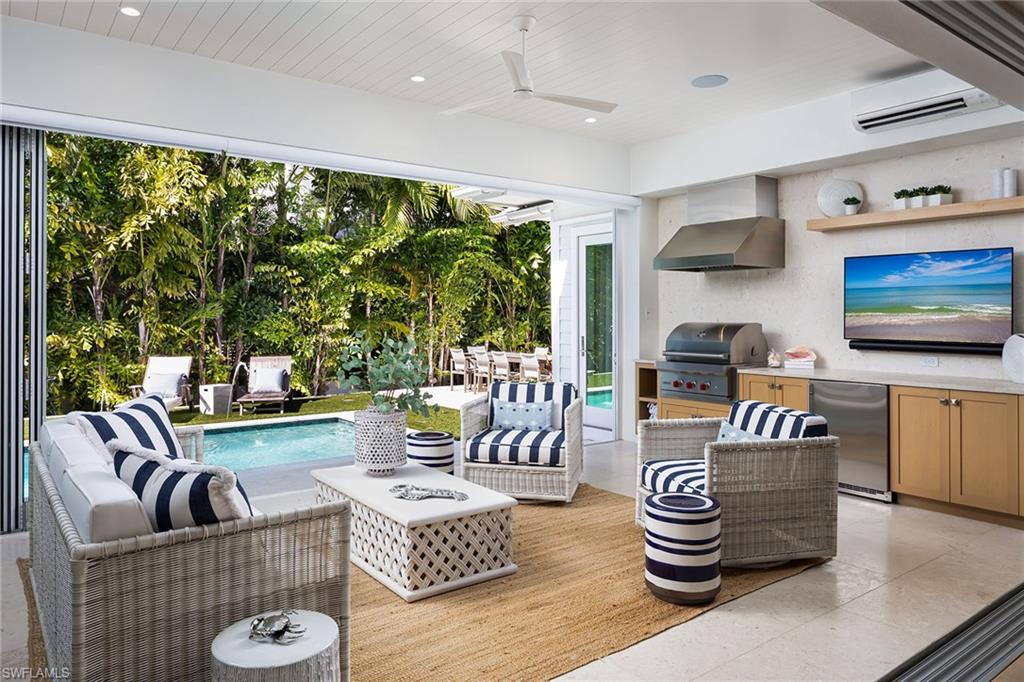 1040 2nd Street South Naples, FL 34102 - Photo 12 of 42 a living room with furniture and a large window