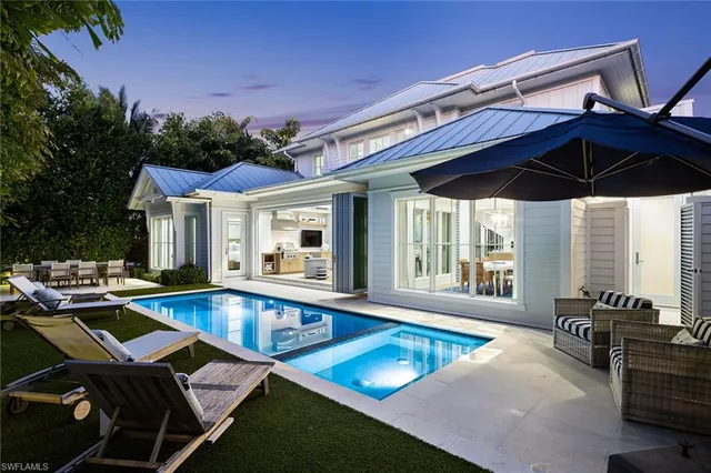 a view of a patio with swimming pool table and chairs