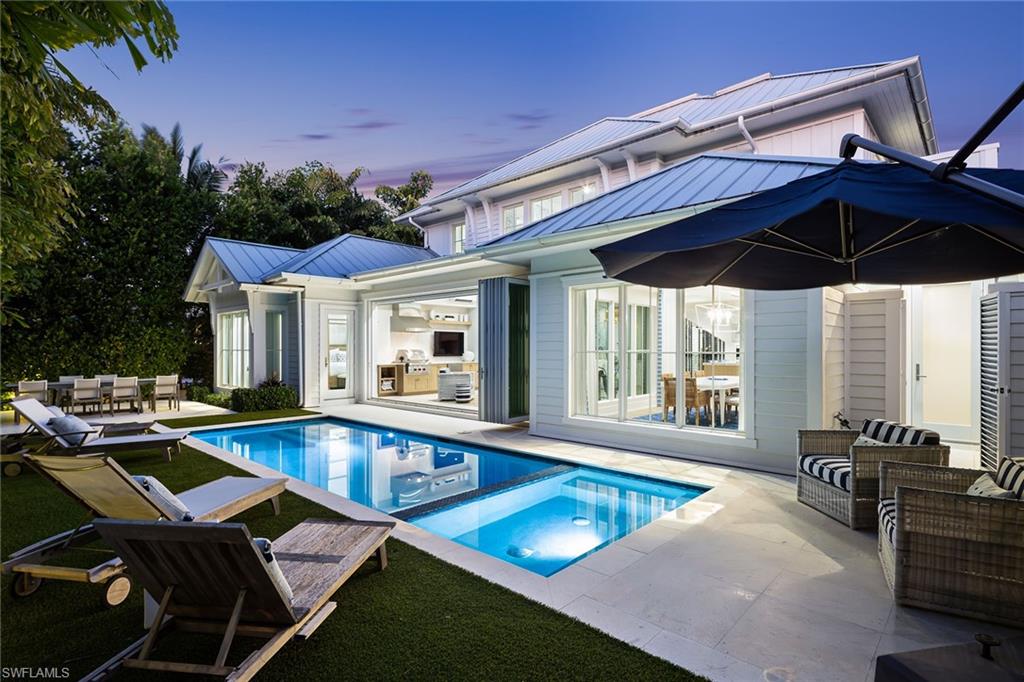 1040 2nd Street South Naples, FL 34102 - Photo 13 of 42 a view of a patio with swimming pool table and chairs