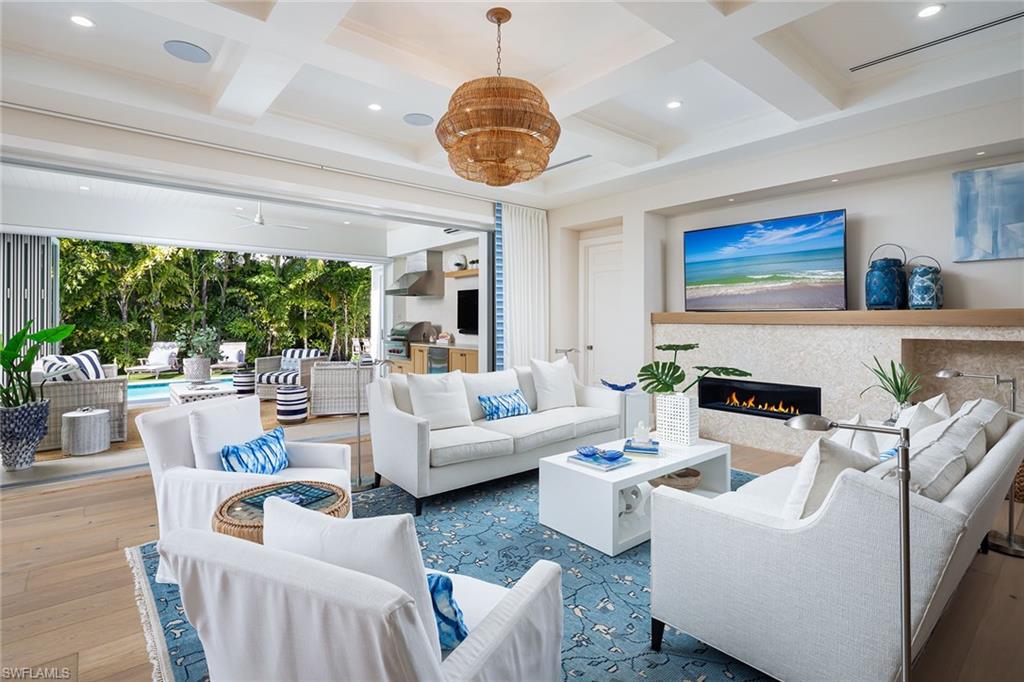 1040 2nd Street South Naples, FL 34102 - Photo 2 of 42 a living room with fireplace furniture and a large window