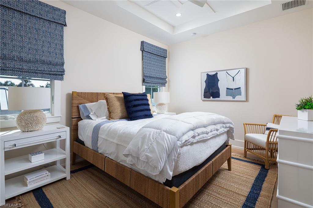 1040 2nd Street South Naples, FL 34102 - Photo 23 of 42 a bedroom with a bed and wooden floor