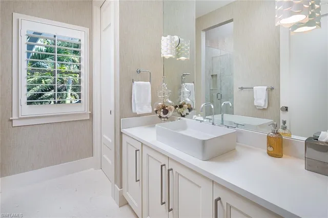 a bathroom with a sink and a mirror