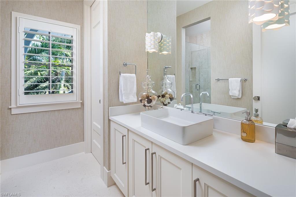 1040 2nd Street South Naples, FL 34102 - Photo 24 of 42 a bathroom with a sink and a mirror