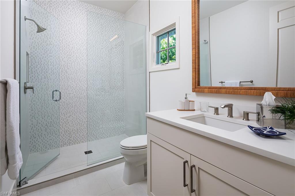 1040 2nd Street South Naples, FL 34102 - Photo 26 of 42 a bathroom with a sink a toilet and shower