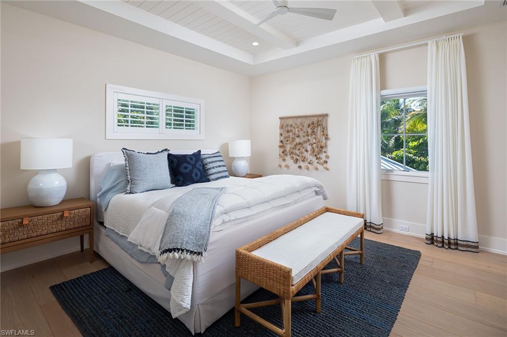1040 2nd Street South Naples, FL 34102 - Photo 27 of 42 a bedroom with a bed and wooden floor