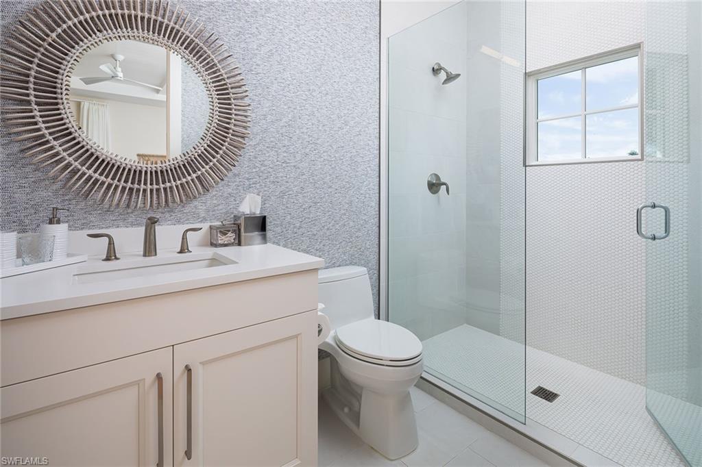1040 2nd Street South Naples, FL 34102 - Photo 28 of 42 a bathroom with a sink mirror toilet and shower