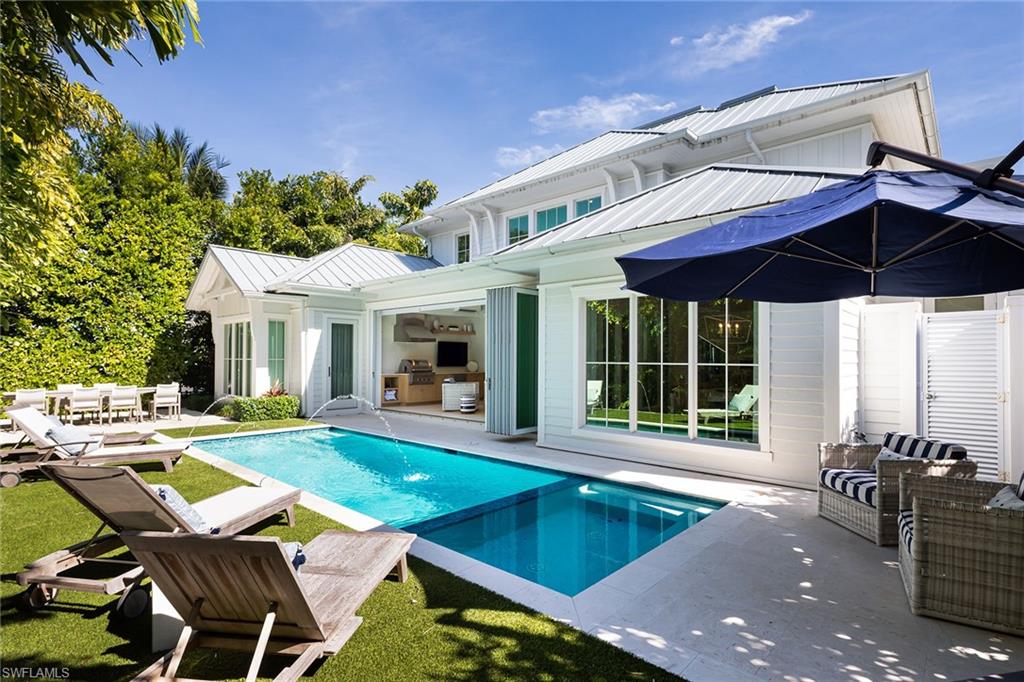 1040 2nd Street South Naples, FL 34102 - Photo 30 of 42 a view of a house with backyard sitting area and swimming pool