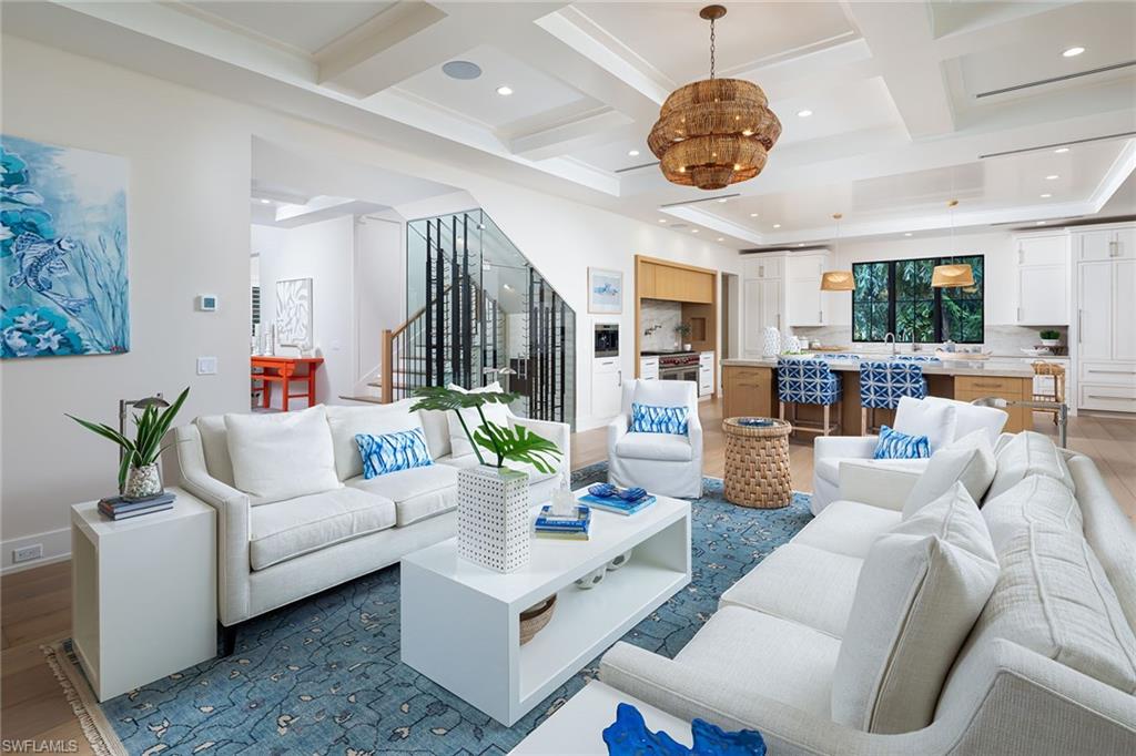 1040 2nd Street South Naples, FL 34102 - Photo 3 of 42 a living room with furniture a chandelier a fireplace and a chandelier