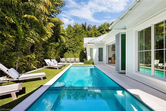 a view of a house with pool and a yard