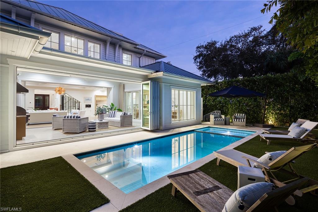 1040 2nd Street South Naples, FL 34102 - Photo 36 of 42 a view of a patio with swimming pool table and chairs