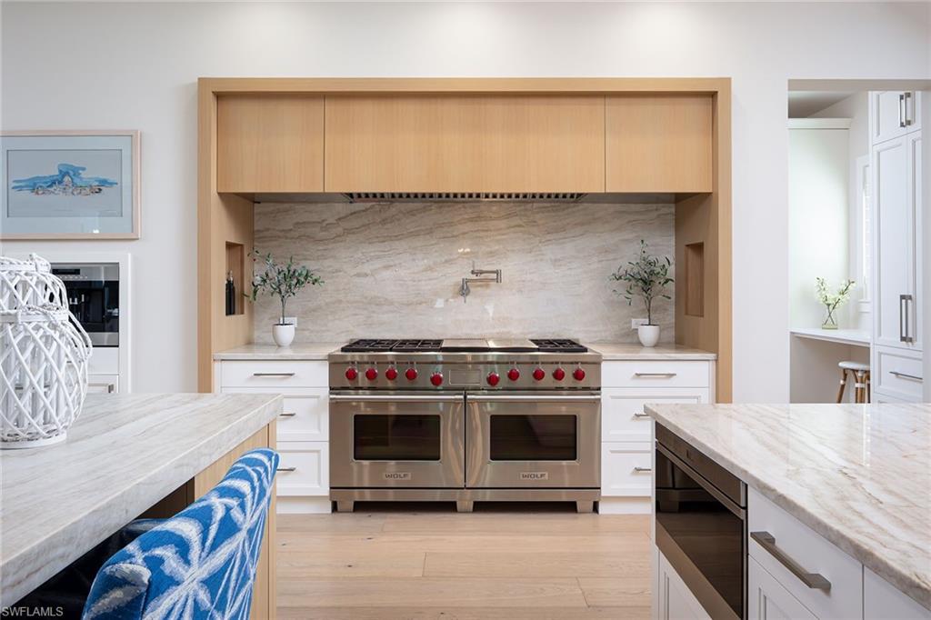 1040 2nd Street South Naples, FL 34102 - Photo 7 of 42 a kitchen with a stove and a sink