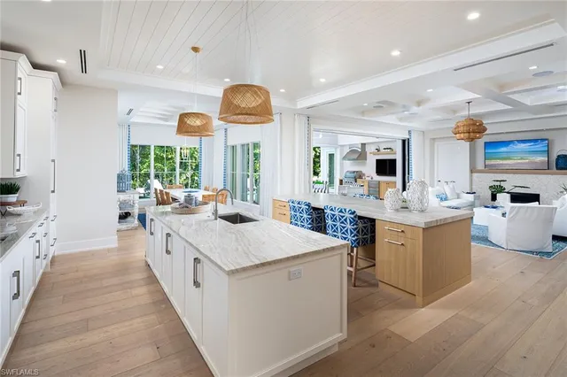 a large kitchen with stainless steel appliances lots of counter space and windows