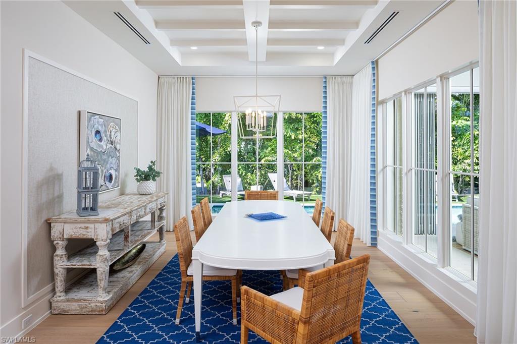 1040 2nd Street South Naples, FL 34102 - Photo 9 of 42 a view of a dining room with furniture window and wooden floor