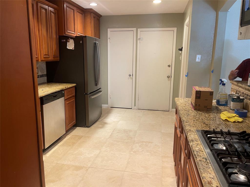 13308 Purple Sage Road Dallas, TX 75240 - Photo 12 of 18 a kitchen with stainless steel appliances granite countertop a refrigerator and a stove top oven