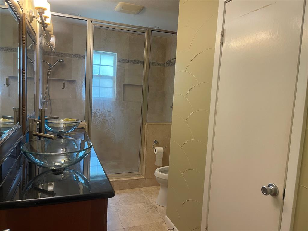 13308 Purple Sage Road Dallas, TX 75240 - Photo 15 of 18 a bathroom with a sink and a mirror