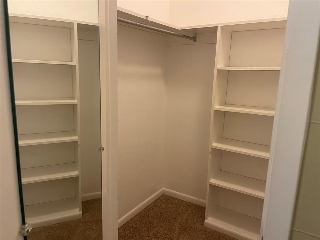 13308 Purple Sage Road Dallas, TX 75240 - Photo 17 of 18 a view of walk in closet with empty racks
