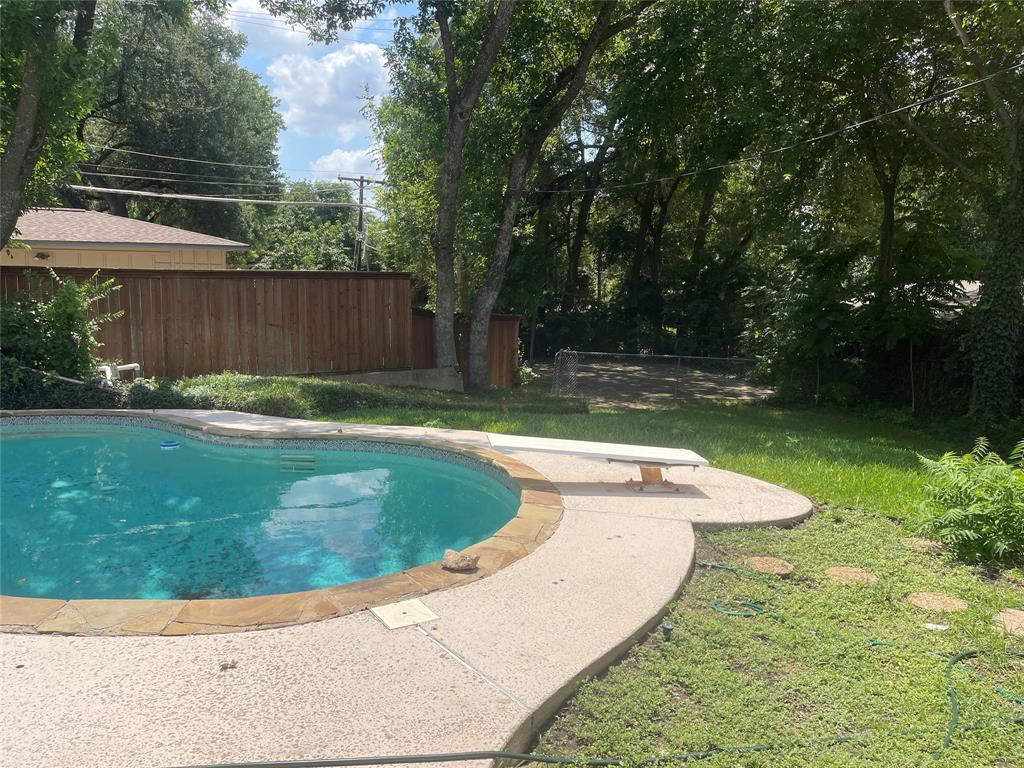 13308 Purple Sage Road Dallas, TX 75240 - Photo 2 of 18 a view of a backyard with a small swimming pool