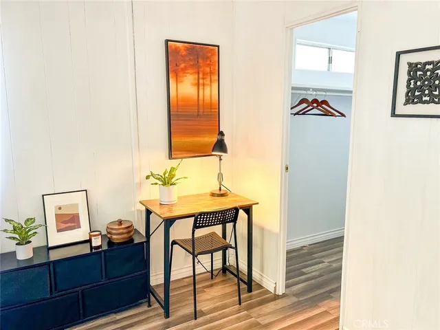a view of a workspace with furniture and wooden floor